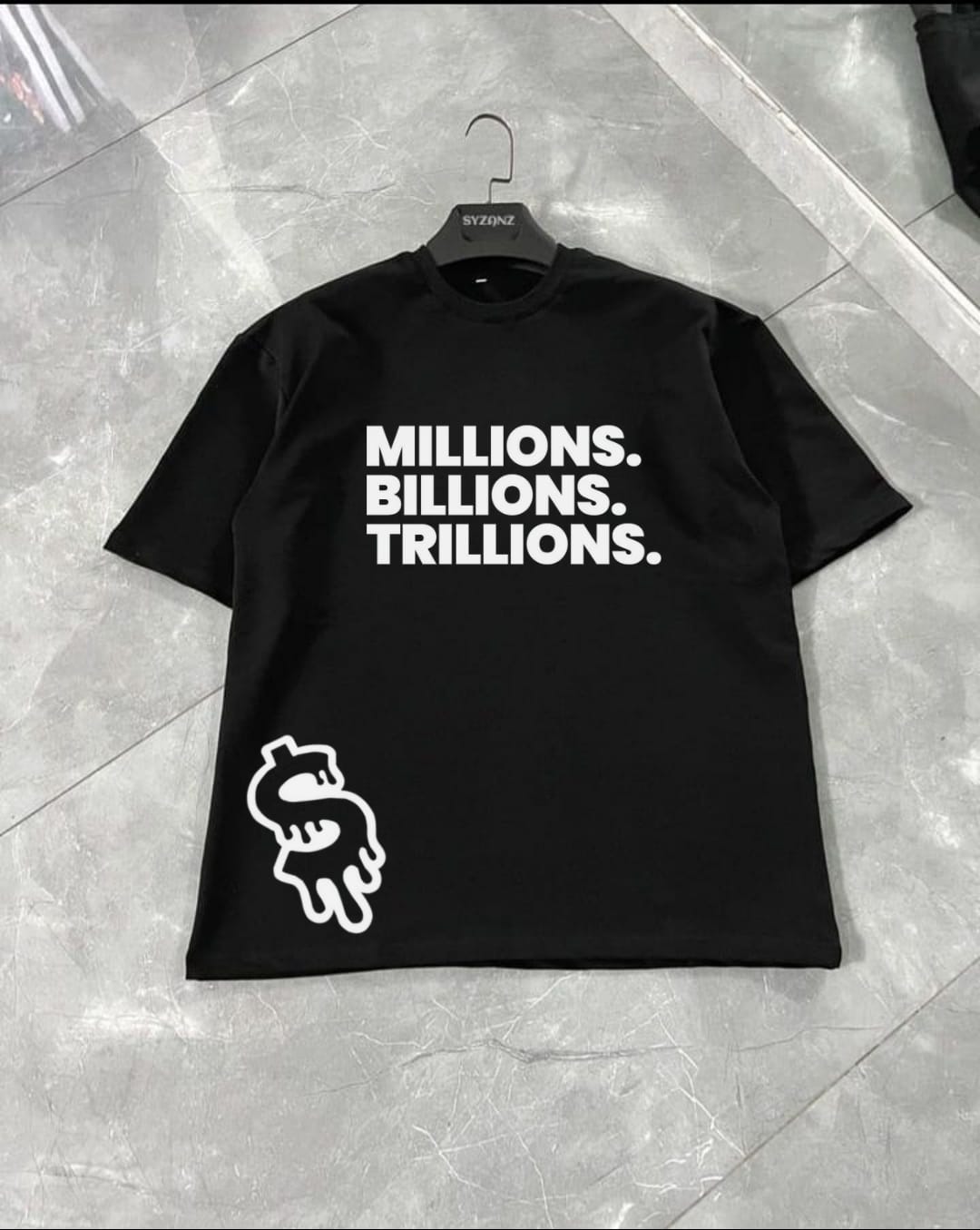 Graphic T-shirt featuring the 'Millionaire' design, showcasing bold typography and sleek, modern elements that exude luxury and success. The design emphasizes the word 'Millionaire,' often paired with symbols of wealth, such as dollar signs or opulent imagery, creating a high-end streetwear aesthetic. Made from soft, premium fabric, this T-shirt combines comfort with a sense of ambition and achievement, perfect for those who aspire to success and want to showcase their drive through fashion