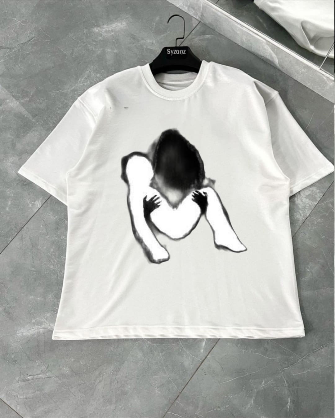 Graphic T-shirt featuring a striking ‘Tears’ design, with stylized tear drops cascading down in vivid detail. The artwork captures an emotional, expressive theme, blending elements of streetwear with artistic flair. The tear drops have intricate shading and unique textures, creating a visually impactful, almost 3D effect. Set against a dark or neutral background, the design is bold yet subtle, ideal for fans of edgy fashion and those who appreciate emotive, statement pieces.