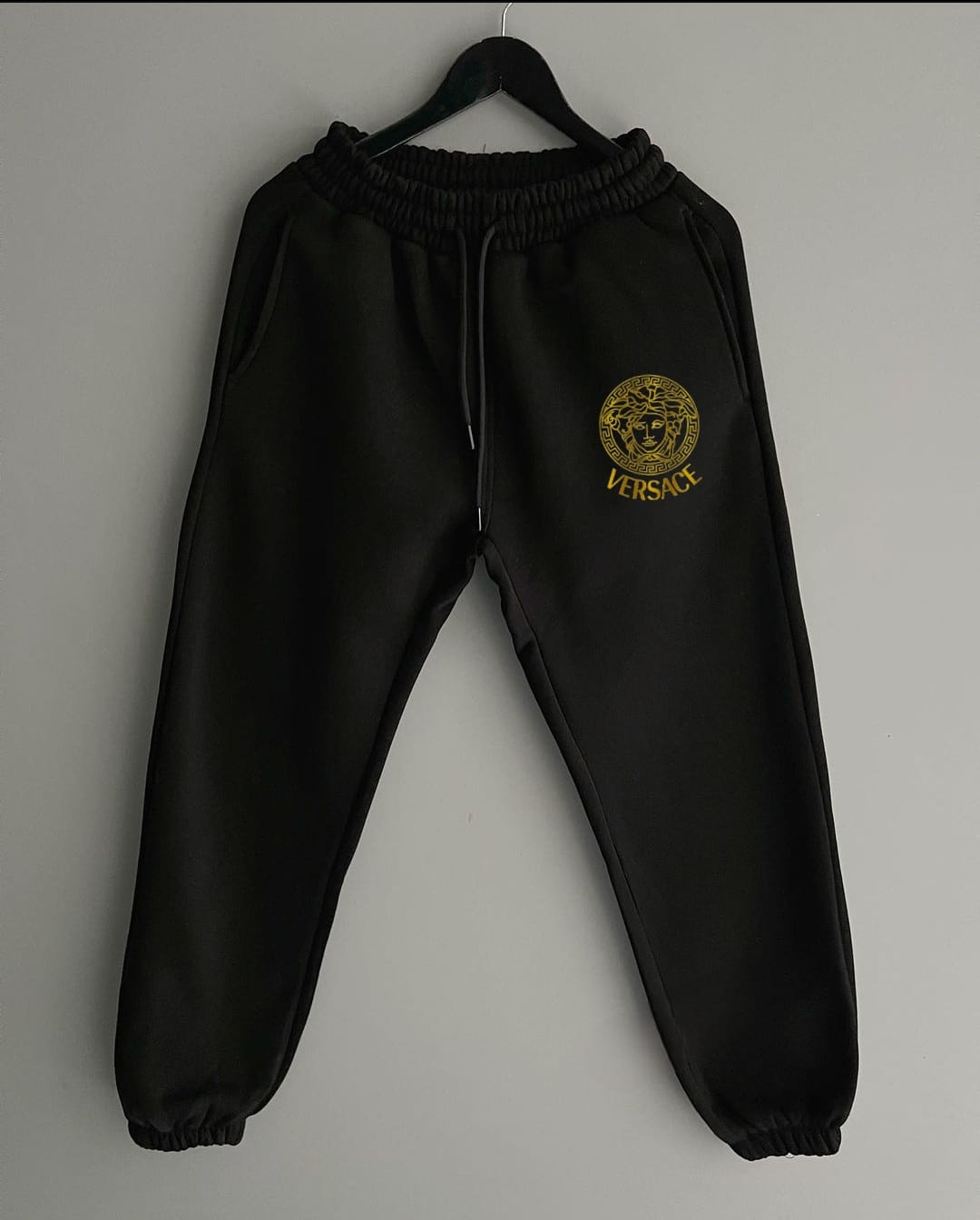 Trousers featuring a stylish Versace print, showcasing the iconic Medusa logo and intricate patterns. The design combines luxury and sophistication, adding a high-fashion touch to your wardrobe. Made from high-quality fabric, these trousers offer both comfort and elegance, perfect for those who appreciate bold, premium streetwear with a classic Versace flair